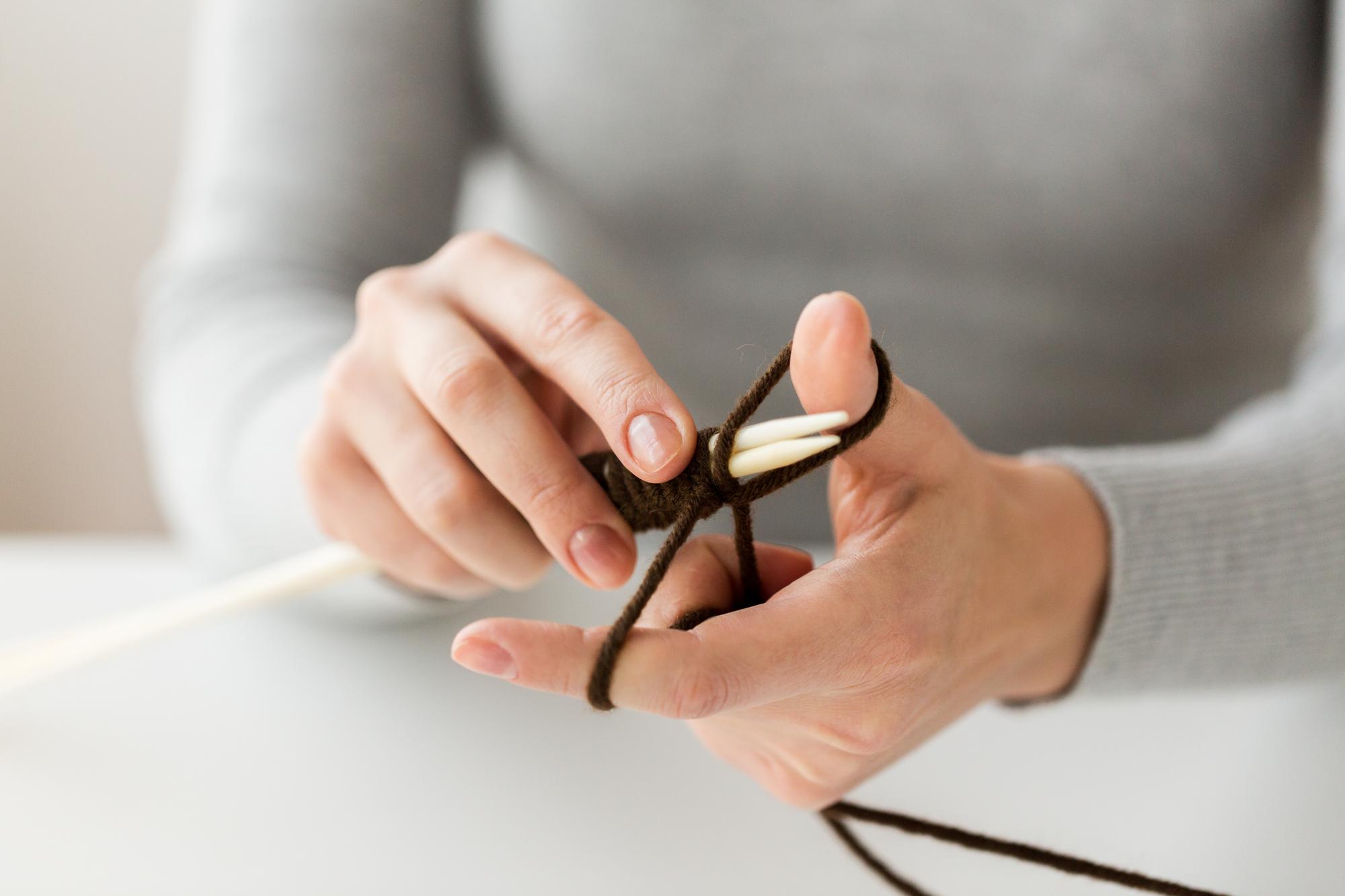 Studio hands at work with hoop and needle